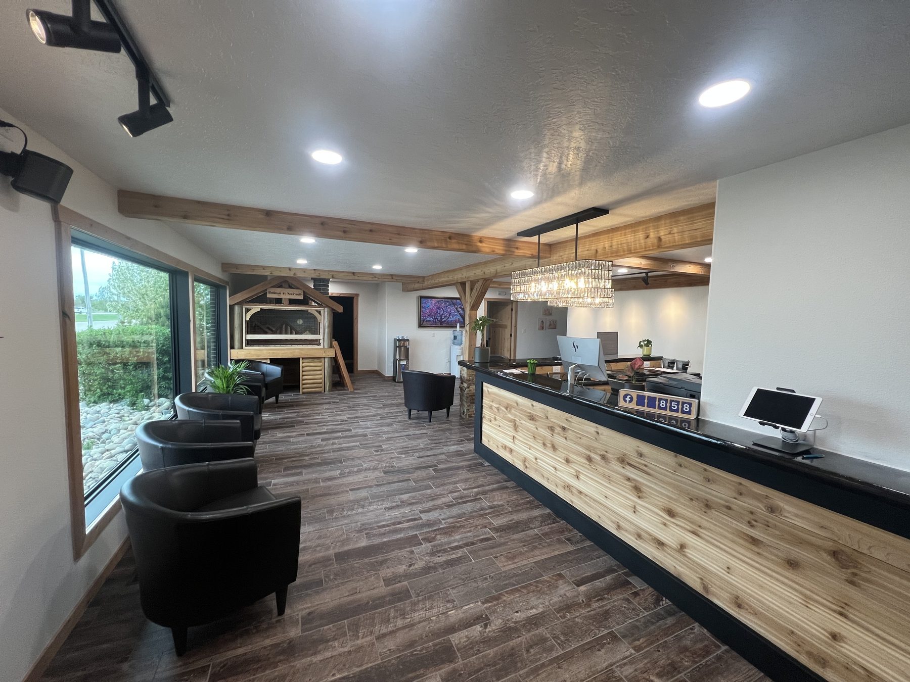Front desk with timber beams and chandelier at True North Chiropractic